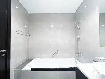 a white bathroom with a tub and a sink at Luxury 2BR in Merano Tower Panoramic City Views in Dubai