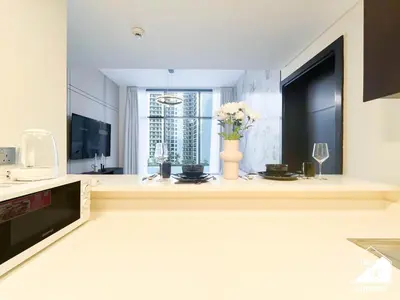 a kitchen with a vase of flowers on a counter at Luxury 2B in Business Bay & Stunning Canal Views in Dubai