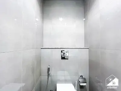 a white bathroom with a toilet and a sink at Luxury 2B in Business Bay & Stunning Canal Views in Dubai