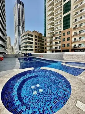 a large swimming pool in a city with tall buildings at Golden Hour Stay Sea View in Marina Dubai in Dubai