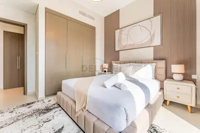 a bedroom with a large white bed and a mirror at Apartment Steps from Burj Khalifa, Dubai Mall & Metro, Act One Act Two Tower 1, Downtown Dubai By Deluxe Holiday Homes in Dubai
