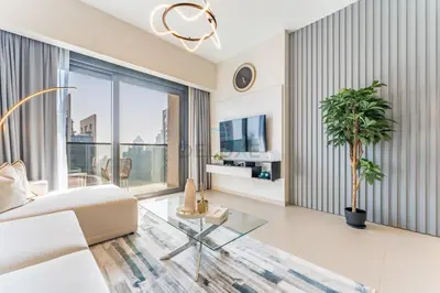 a living room with a white couch and a glass table at Apartment Steps from Burj Khalifa, Dubai Mall & Metro, Act One Act Two Tower 1, Downtown Dubai By Deluxe Holiday Homes in Dubai