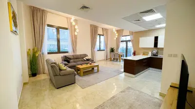 a living room with a couch and a table at Joya Verde Residence - 1BHK Huge Apartment in Dubai