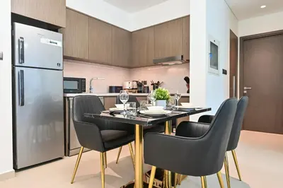 a kitchen and dining room with a table and chairs at Majestic ActOne 1BR dowtown Dubai in Dubai