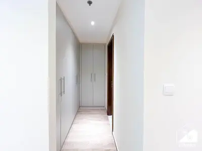an empty corridor with white walls and a hallway with white ceilings at Stunning 2-Bedroom Apartment with Canal Views in Dubai