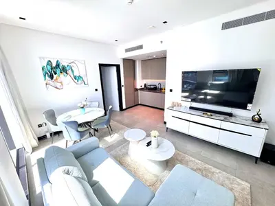 a living room with a blue couch and a tv at 5 Star Apartment Dubai Burj KhalifaView in Dubai