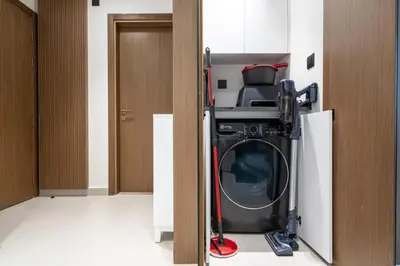 a washer and dryer in a room at Trillionaire Bayhouse - Chic 1BR with Views, Pool and Gym in Dubai