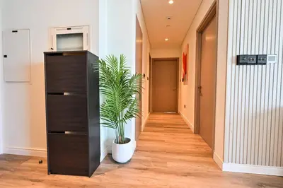 a plant in a black dresser in a hallway at Comfy 2BR Act 1 Near Dubai Mall in Dubai
