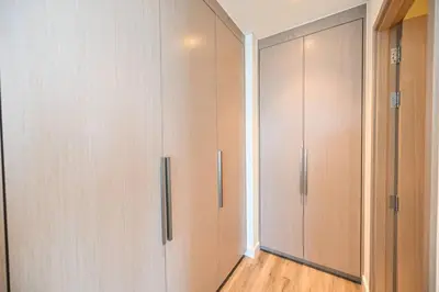 a room with two closets with wooden floors at Comfy 2BR Act 1 Near Dubai Mall in Dubai