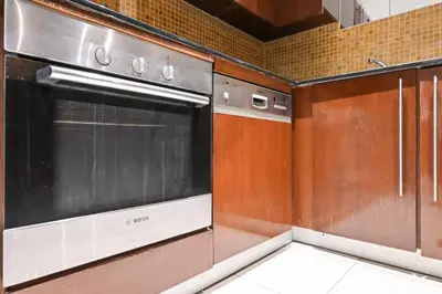 a kitchen with a stainless steel oven and cabinets at Stylish 1BR in 8 Boulevard Walk in Dubai