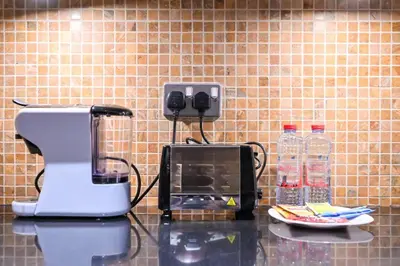 a kitchen counter with a phone and a microwave at Stylish 1BR in 8 Boulevard Walk in Dubai