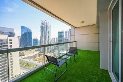a balcony with chairs and a view of the city at Stylish 1BR in 8 Boulevard Walk in Dubai