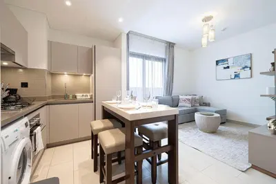 a kitchen with a table with wine glasses on it at Lux 1 Bed room partment in Sobha Creek Vistas Reserve tower at 9th floor in Dubai