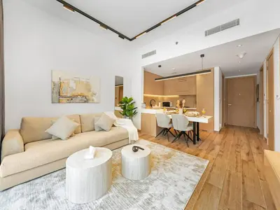 a living room with a couch and a table at Brand New Luxury 2Bedroom in JVC with 5 Star Amenities in Dubai