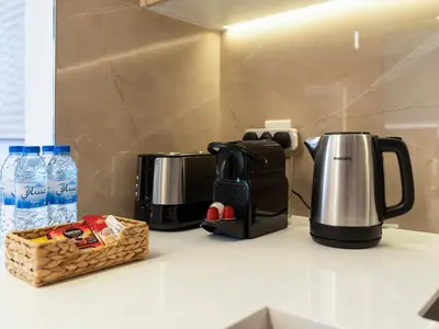 a kitchen counter with a coffee maker and a toaster at Brand New Luxurious 2 Bed in JVC with Padel Court in Dubai