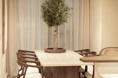 a table with a potted tree on top of it at Seraya Residence 1 - 4BDR - Burj Views - Amenities in Dubai