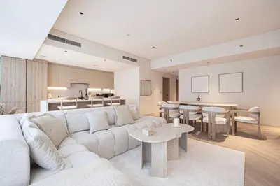 a living room with a white couch and a table at Seraya Residences at Marquise Square Tower in Dubai