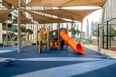 a playground with a slide in a building at Seraya Residence 3 - 4BDR - Burj Views - Amenities and Concierge in Dubai