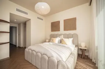 a bedroom with a large bed with a large white bedspread at Seraya Residence 3 - 4BDR - Burj Views - Amenities and Concierge in Dubai