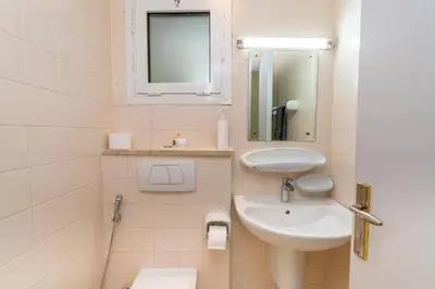 a white bathroom with a sink and a mirror at White Sage High Floor 1BR Metro Access JLT in Dubai