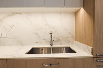 a kitchen sink with a marble counter top at Stylish Studio at Berkeley Place by Ellington in Dubai