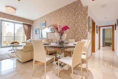 a dining room and living room with a table and chairs at Few Metres from Marina Beach, Arabian Gulf Views - Trident Grand Residences, Dubai Marina by Deluxe Holiday Homes in Dubai