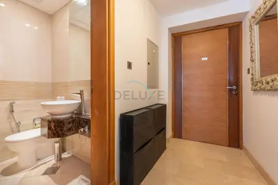 a bathroom with a sink and a toilet and a door at Few Metres from Marina Beach, Arabian Gulf Views - Trident Grand Residences, Dubai Marina by Deluxe Holiday Homes in Dubai
