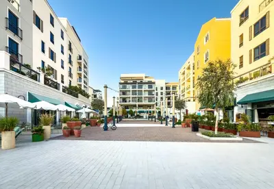 an empty street in a city with buildings at Goldbest Beachfront 2BR La Mer in Dubai