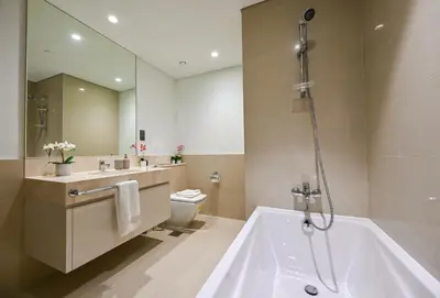 a bathroom with a tub and a sink and a toilet at Majestic Act2 1BR Dowtown Dubai in Dubai