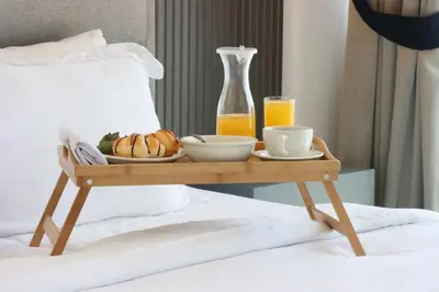 a tray of food on a bed with a breakfast on it at Livbnb Beachfront 2BR in Address JBR Sea & Ain Dubai Views in Dubai
