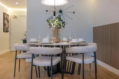 a dining room with a table and six chairs at High-Floor 2BR with Pool and City Views, Near Tram Station and Dubai Marina Walk, Marina Heights, Dubai Marina by Deluxe Holiday Homes in Dubai