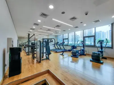 a gym with treadmills and cardio equipment in a building at High-Floor 2BR with Pool and City Views, Near Tram Station and Dubai Marina Walk, Marina Heights, Dubai Marina by Deluxe Holiday Homes in Dubai