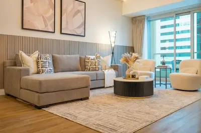 a living room with a couch and a table at High-Floor 2BR with Pool and City Views, Near Tram Station and Dubai Marina Walk, Marina Heights, Dubai Marina by Deluxe Holiday Homes in Dubai