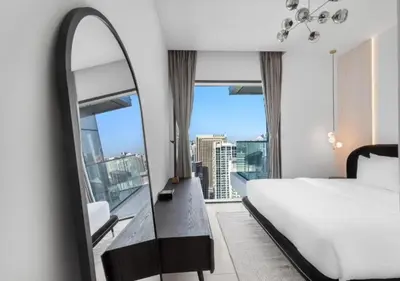 a hotel room with a bed and a mirror at Novity Signature Homes in Dubai