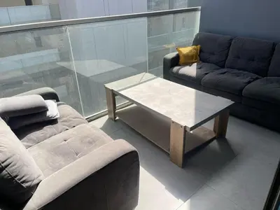 a living room with a couch and a coffee table at hostel in Dubai