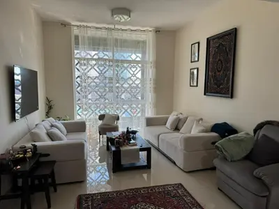 a living room with couches and a large window at Affordable master bedroom hotel apartment in Dubai