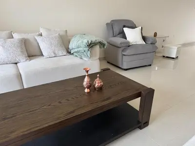 a living room with a couch and a coffee table at Affordable master bedroom hotel apartment in Dubai