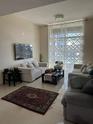 a living room with two couches and a rug at Stylish 2BHK in Prime Location in Dubai