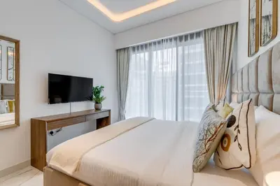 a bedroom with a large bed and a television at GLOBALSTAY Azizi Riviera 59 in Dubai