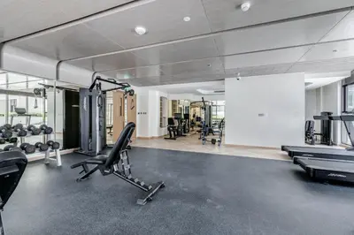 a gym with several treadmills and cardio machines at GLOBALSTAY Azizi Riviera 59 in Dubai