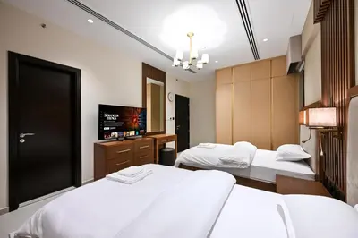 a hotel room with two beds and a flat screen tv at Luxury 3BR Full Burj Khalifa View Stay by World's Tallest Tower in Dubai