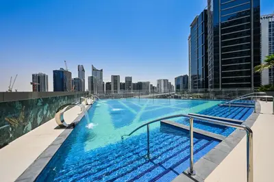 a swimming pool on the roof of a building with a city at Luxury 3BR Full Burj Khalifa View Stay by World's Tallest Tower in Dubai