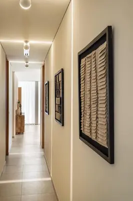 a hallway with paintings on the walls at Seraya at Residence 110 in Dubai