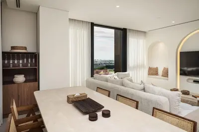 a living room with a table and a couch at Seraya at Residence 110 in Dubai