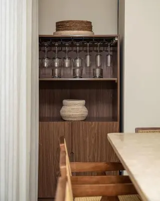 a kitchen with a shelf with bowls and plates at Seraya at Residence 110 in Dubai