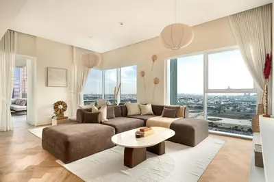 a living room with a couch and a table at Seraya Residences at Urban Oasis by Missoni in Dubai