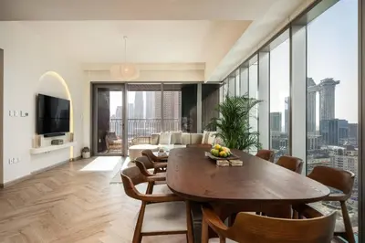 a living room with a table and a couch at Seraya Residence 7 - 4BDR - Burj and DIFC skyline Views in Dubai