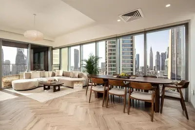 a living room with a couch and a table at Seraya Residence 7 - 4BDR - Burj and DIFC skyline Views in Dubai