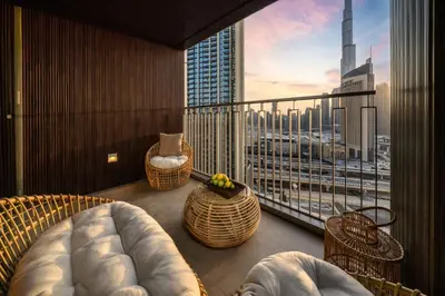 a room with a balcony with a view of a city at Seraya Residence 7 - 4BDR - Burj and DIFC skyline Views in Dubai