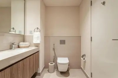 a bathroom with a toilet and a sink and a shower at Seraya Residence 7 - 4BDR - Burj and DIFC skyline Views in Dubai